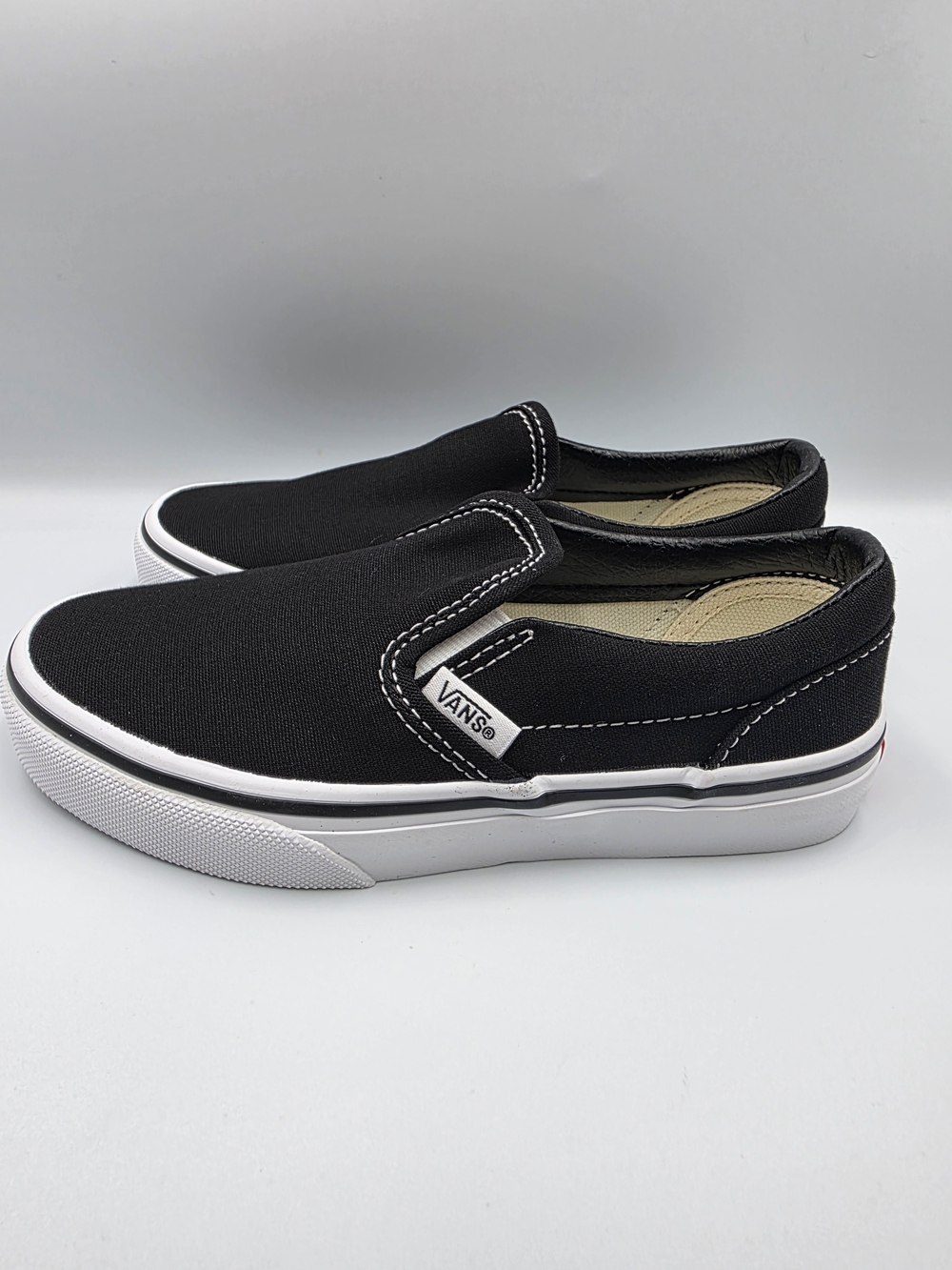 Vans Kids Slip-On Canvas Sneakers in Black and White
